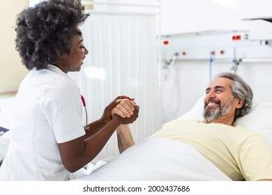 Healthcare Concept Of Professional Doctor Consulting And Comforting Elderly Patient In Hospital Bed Or Counsel Diagnosis Health. Medical Doctor Or Nurse Holding Senior Patient's Hands