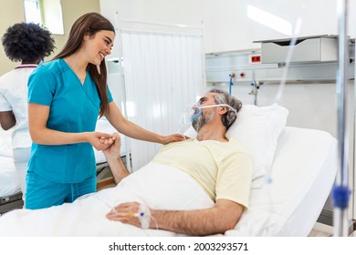 Healthcare Concept Of Professional Doctor Consulting And Comforting Elderly Patient In Hospital Bed Or Counsel Diagnosis Health. Medical Doctor Or Nurse Holding Senior Patient's Hands