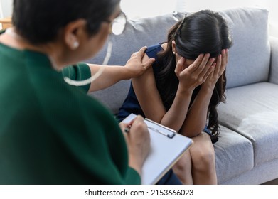 Healthcare concept: Young Asian woman received a consultant with professional psychologist doctor in psychotherapy session or counsel diagnosis health. Mental health care problem concept. - Shutterstock ID 2153666023