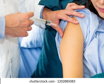 healthcare concept.Doctor vaccinating patient. Close up hand holding syringe ready inject to arm. 