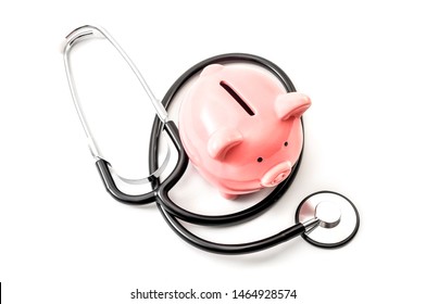 Healthcare Cost And The High Price Of Quality Health Care Insurance Concept Theme With A Stethoscope And A Pink Piggy Bank Isolated On White Background