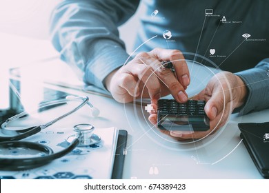 Healthcare costs and fees concept.Hand of smart doctor used a calculator for medical costs in modern hospital with VR icon diagram