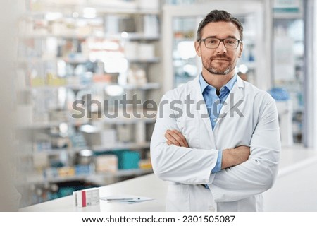 Healthcare, crossed arms and portrait of a male pharmacist standing in a pharmacy clinic. Pharmaceutical, medical and mature man chemist with confidence by the counter of medication store dispensary.