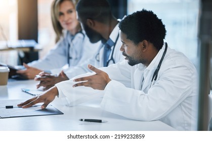 Healthcare, Diversity And A Medical Conference, Male Doctor In Discussion Or Meeting With Team. Teamwork, Collaboration And Communication, Health Care Workers Talking And Planning At Hospital Office.