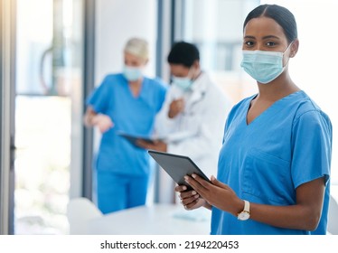 Healthcare, Doctor Or A Nurse On A Tablet, Consulting In A Hospital Boardroom. Medical Workers Meeting To Consult, Communication Online. Covid Management And Teamwork, Doctors Wearing Surgical Masks