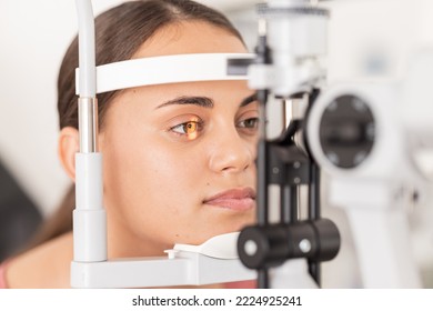 Healthcare, eyes and woman eye test at a clinic for vision, health and eyesight on a slit lamp examination. Face, eye care and girl consulting optometrist for sight, wellness and glaucoma testing