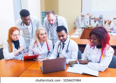 healthcare. A group mixedrace of student medical students communicates in front of a laptop. Discussion of the diagnosis.