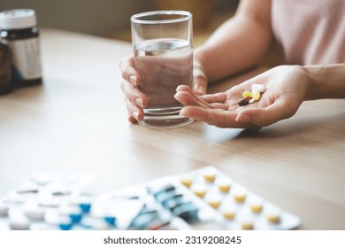 Healthcare Harmony: Close-Up Hands Holding Medication and Water Glass for Optimal Wellness, Pharmaceutical Treatment and mental health treatment - Powered by Shutterstock