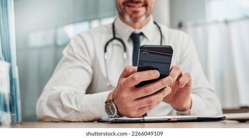 Healthcare, hospital and hands of doctor with phone for social media, research and online consulting. Communication, insurance and man with smartphone for wellness app, medical data and telehealth - Powered by Shutterstock