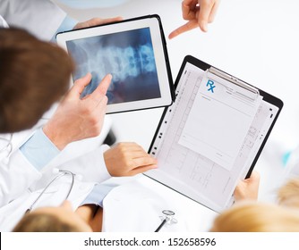 Healthcare, Hospital And Medical Concept - Group Of Doctors Looking At X-ray On Tablet Pc