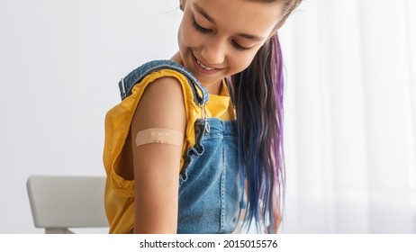 Healthcare And Inoculation Concept. Portrait Of Smiling Teen Patient Showing Vaccinated Arm With Plaster On Shoulder After Coronavirus Vaccination, Looking At Hand. Antiviral Vaccine, Banner, Panorama