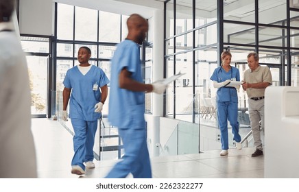 Healthcare, insurance and nurse with a people walking in a busy hospital for treatment or diagnosis. Medical, diversity and support with a medicine professional team at work in a health clinic - Powered by Shutterstock