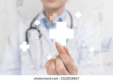 Healthcare and medical background. Doctor, surgeon, holding medical cross symbol. Concept of health care and insurance. Female doctor holding white cross in hand - Powered by Shutterstock