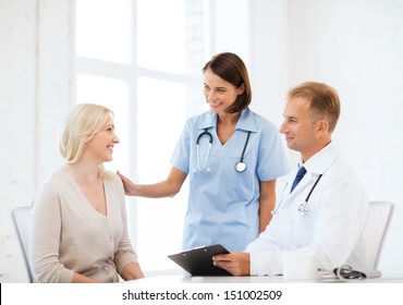 Healthcare And Medical Concept - Doctor And Nurse With Patient In Hospital