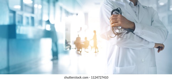 Healthcare and medical concept. Medicine doctor with stethoscope in hand and Patients come to the hospital background. - Shutterstock ID 1124727410