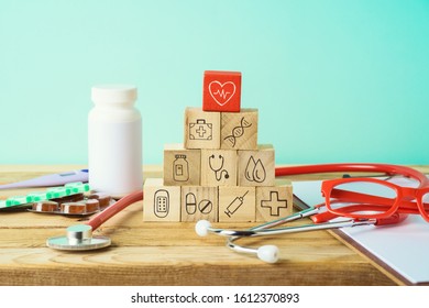 Healthcare And Medical Insurance Concept With Wooden Blocks And Medical Icons On Wooden Table