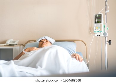 Healthcare Medical Patient High Fever, Older Asian Sick Sleeping On Bed In Hospital While Disease Illness Cold Virus Fever With Medical Drip Intravenous Needle IV Solution, Health Insurance Care Shot