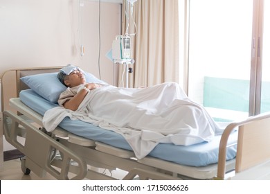 Healthcare Medical Patient High Fever, Older Asian Sick Sleeping On Bed In Hospital While Disease Illness Cold Virus Fever With Medical Drip Intravenous Needle IV Solution, Health Insurance Care Shot