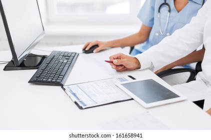 Healthcare, Medical And Technology Concept -  Group Of Doctors Looking At Tablet Pc