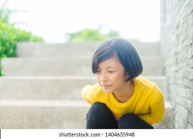 Healthcare Medical In Teenager Concept : First Period In Pre Teenager Girl At School, She Have A Stomachache Or Menstruation Pain Or Period Pain Sitting On A Stairs.hepatitis Virus On Tween Girl.