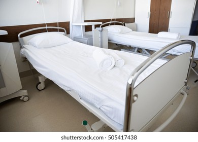 healthcare, medicine and ambulatory concept - hospital ward with clean empty beds - Powered by Shutterstock