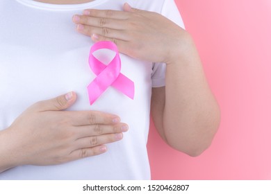 Healthcare, medicine and breast cancer awareness concept. Closeup on woman chest with pink breast cancer awareness ribbon. - Shutterstock ID 1520462807