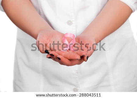healthcare and medicine concept - hands of  female doctor with pink cancer awareness ribbon. doctor supporting AIDS HIV prevention
