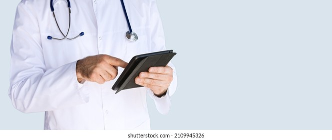 Healthcare, Medicine Concept: Handsome Doctor Thinking About Diagnosis On Tablet Computer Isolated Over Grey Color Background