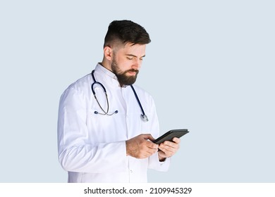 Healthcare, medicine concept: Handsome Doctor thinking about diagnosis on tablet computer isolated over grey color background - Powered by Shutterstock