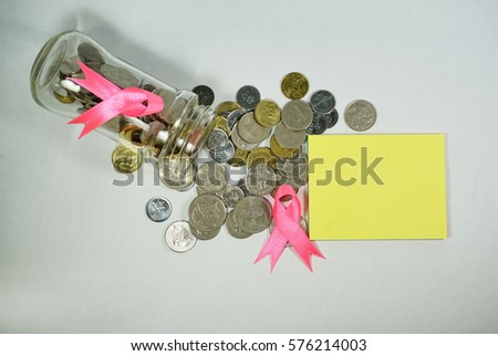Healthcare and Medicine Concept - A pink ribbon and a coins with a blank space to write a message on a white background. Breast cancer awareness pink sign symbol for help illness people