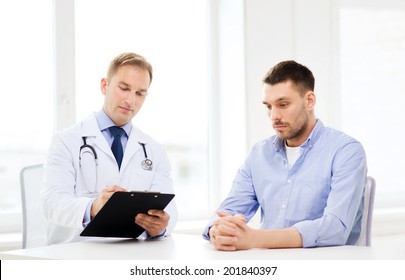 Healthcare And Medicine Concept - Serious Doctor With Clipboard And Patient In Hospital