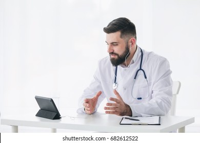 Healthcare, Medicine Concept: Sincere Doctor Having A Video Chat Through Laptop Computer And Giving Positive Encouragement