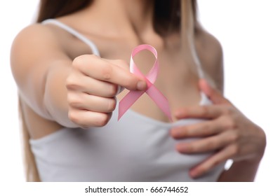 healthcare and medicine concept. Woman hand holding pink breast cancer awareness ribbon. - Shutterstock ID 666744652