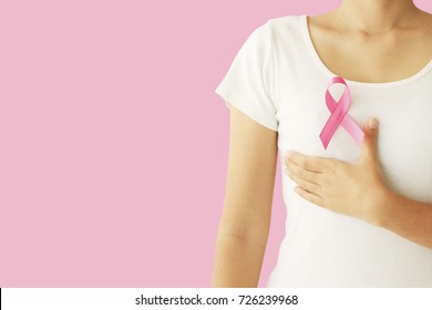 healthcare and medicine concept. Woman hand holding pink breast cancer awareness ribbon. - Shutterstock ID 726239968