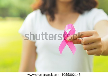 healthcare and medicine concept. Woman hand holding pink breast cancer awareness ribbon.