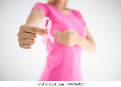 healthcare and medicine concept - womans hands holding pink breast cancer awareness ribbon - Shutterstock ID 744836020