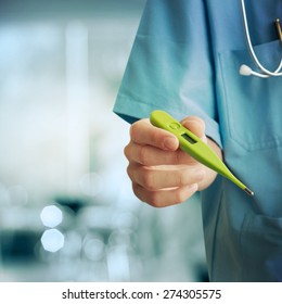 Healthcare And Medicine. Doctor holding thermometer