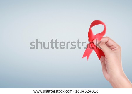 Healthcare and medicine. hands holding ribbon