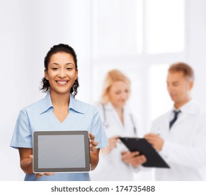 Healthcare, Medicine And Technology Concept - Smiling African American Female Doctor Or Nurse With Tablet Pc Computer