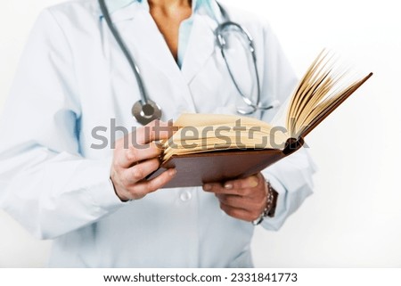 healthcare and medicine- young doctor reading a treatise