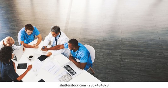 Healthcare, meeting and doctors with nurses, laptop or tablet from above for surgery, advice or planning. Hospital, teamwork or people in office for help, collaboration or results, review or analysis - Powered by Shutterstock