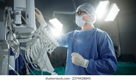 Healthcare, monitor and vital with a doctor in theater getting ready for surgery in a hospital operating room. Medical, technology and equipment with a surgeon in a clinic as a medicine professional - Powered by Shutterstock