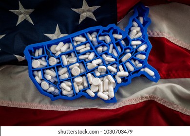 Healthcare, opioid epidemic and drug abuse concept with the map of USA filled with oxycodone and hydrocodone pharmaceutical pills on the American flag