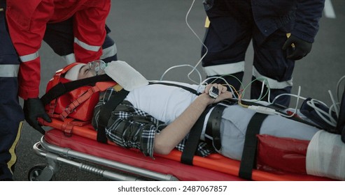 Healthcare, paramedic and help patient in road on scene for emergency, rescue and support. Emt team, people and stretcher for injured person on accident for medical service, care and first aid - Powered by Shutterstock