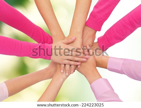 healthcare, people, gesture and medicine concept - close up of women hands on top of each other over green background