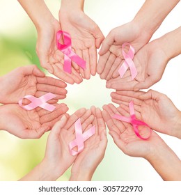healthcare, people and medicine concept - close up of women hands with cancer awareness ribbons over green background - Shutterstock ID 305722970