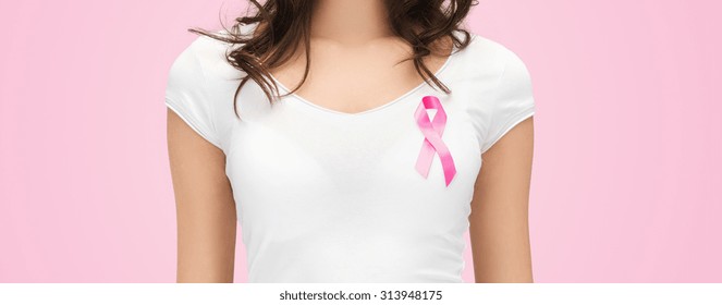 healthcare, people and medicine concept - close up of woman in blank t-shirt with pink breast cancer awareness ribbon - Powered by Shutterstock