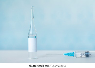 Healthcare And Pharmaceutical Drugs Concept With Syringe And Vaccine Vial With Liquid. Drug Vial Has Blank Label Copyspace. Production Of Vaccines And Immunization Of The Population. Mockup