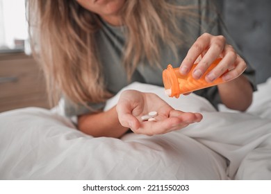 Healthcare, Pills In Hand And Woman In Bedroom At Home Taking Prescription Medicine. Mental Health, Depression And Medication For Health Care. Covid, Flu And Drugs, Sick In Bed With Virus Symptoms.