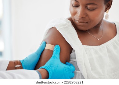 Healthcare, plaster and doctor helping a patient after an injection or vaccine in the hospital. Consultation, appointment and hands of medical worker putting a bandaid on a woman in a medicare clinic - Powered by Shutterstock